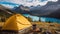 Camping with holding cup in yellow tent open with Peyto Lake in Icefields Parkway at Canada