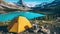 Camping with holding cup in yellow tent open with Peyto Lake in Icefields Parkway at Canada