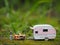 Camping, holiday, staycation, travelling and recreation conceptual design. Miniature toy and mini camper van at outdoor.