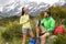 Camping lifestyle young people eating lunch outdoors hiking on New Zealand mountain trail track. Couple trampers