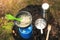 Camping meal - preparing oatmeal porridge on portable gas burner outdoors