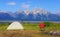 Camping in the mountain wild flowers with the grand tetons mountain range in the back ground