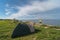 Camping in nature on a sea cliff in Paldiski, a young girl near a tent in the summer