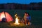 Camping night couple cook by campfire romantic