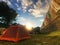 Camping place outdoors. Tent on nature sunset landscape. Panorama