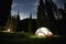 Camping tent at camping in the mountain forest under night sky