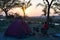 Camping tent, chairs and camping gear. Sunrise over Okavango River, Namibia Botswana border. Adventure traveling and outdoor activ