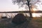 Camping tent, chairs and camping gear. Sunrise over Okavango River, Namibia Botswana border. Adventure traveling and outdoor activ