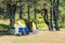 camping tent and a couple of chairs in a picturesque place among the pine
