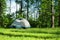 Camping tent erected on grass under trees