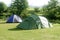 Camping tent field over green grass
