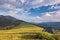 Camping tent in the mountains. Summer, blue sky, clouds and high