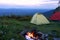 The camping with tents and bonfire.