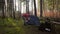 Camping, tourism and travel concept. Man setting up tent outdoors. Hiker assembles campsite tent in the autumnal forest