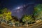 Camping under starry sky and Milky Way arc, with details of its colorful core, outstandingly bright, captured in Southern Africa.