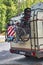 A camping van with a cycle carrier attached to the rear with two bicycles with infant seat and a child`s bike