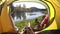 Camping woman lying in tent Close up of Girl feet wearing hiking boots relaxing on vacation POV