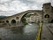 Camprodon, Spain, May 26, 2018: Medieval bridge with yellow ties in Girona, Spain