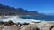 Camps Bay Beach in Cape Town. Turquoise waves foaming in the sand.