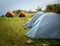 Camps with orange outer fly on a Camp Ground. Nag Tibba, Himalayan region of Uttarakhand. Trekking And Camping