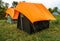 Camps with orange outer fly on a Camp Ground. Nag Tibba, Himalayan region of Uttarakhand. Trekking And Camping