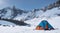 Campsite on the edge of a snowy cliff, with a breathtaking view of mountain ranges and a gentle snowfall.