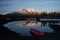 Campsite with orange tent and canoe on a lake