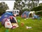 Campsite With Pitched Tents And Campervan