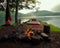 Campsite with a tent, chair, blanket, chair and campfire in the Adirondack Mountain Wilderness.