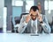 It can be a tough job making it to the top. a young businessman looking stressed out in an office.