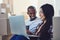 We can buy so many of our home essentials online. a young couple using a laptop while moving house.