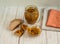 A can of chutney, whole grain bread, linen napkins on a light wooden background.