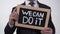 We can do it motivation phrase on blackboard in businessman hands, support