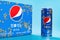 Can of pepsi sweet-scented osmanthus with a box of the same thing on blue background.This is a