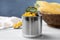 Can of preserved corn on white wooden table