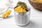 Can of preserved corn on white wooden table