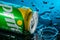 Can of Sprite with splashes of water on a black background and water drops