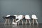 Can this wait get any longer. a young man lying down on a row of chairs while waiting in line for a job interview.