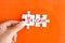 We can â€“ positive message on puzzle pieces, orange background