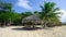 Cana umbrella on white beach. Sun lounger