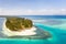 Canabungan Island with sandy beach. Tropical island with white beach on the large atoll, aerial view