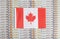 Canada flag on a background from dollar banknotes. Concept of the relationship of the Money canada in relation to the dollar, the