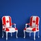 Canada flag chairs on blue background with copy space