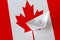 Canada flag depicted on paper origami ship closeup. Handmade arts concept