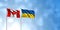Canada Flag with Ukraine Flag, with a cloudy sky