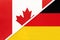 Canada and Germany, symbol of national flags from textile. Championship between two countries