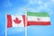 Canada and Iran two flags on flagpoles and blue cloudy sky