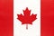 Canada national fabric flag, textile background. Symbol of international world north America country