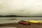 Canada Ontario Lake two rivers grey morning dark atmosphere Canoe Canoes parked beach water in Algonquin National Park