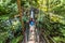 Canada travel tourist woman walking in famous attraction Capilano Suspension Bridge in North Vancouver, British Columbia